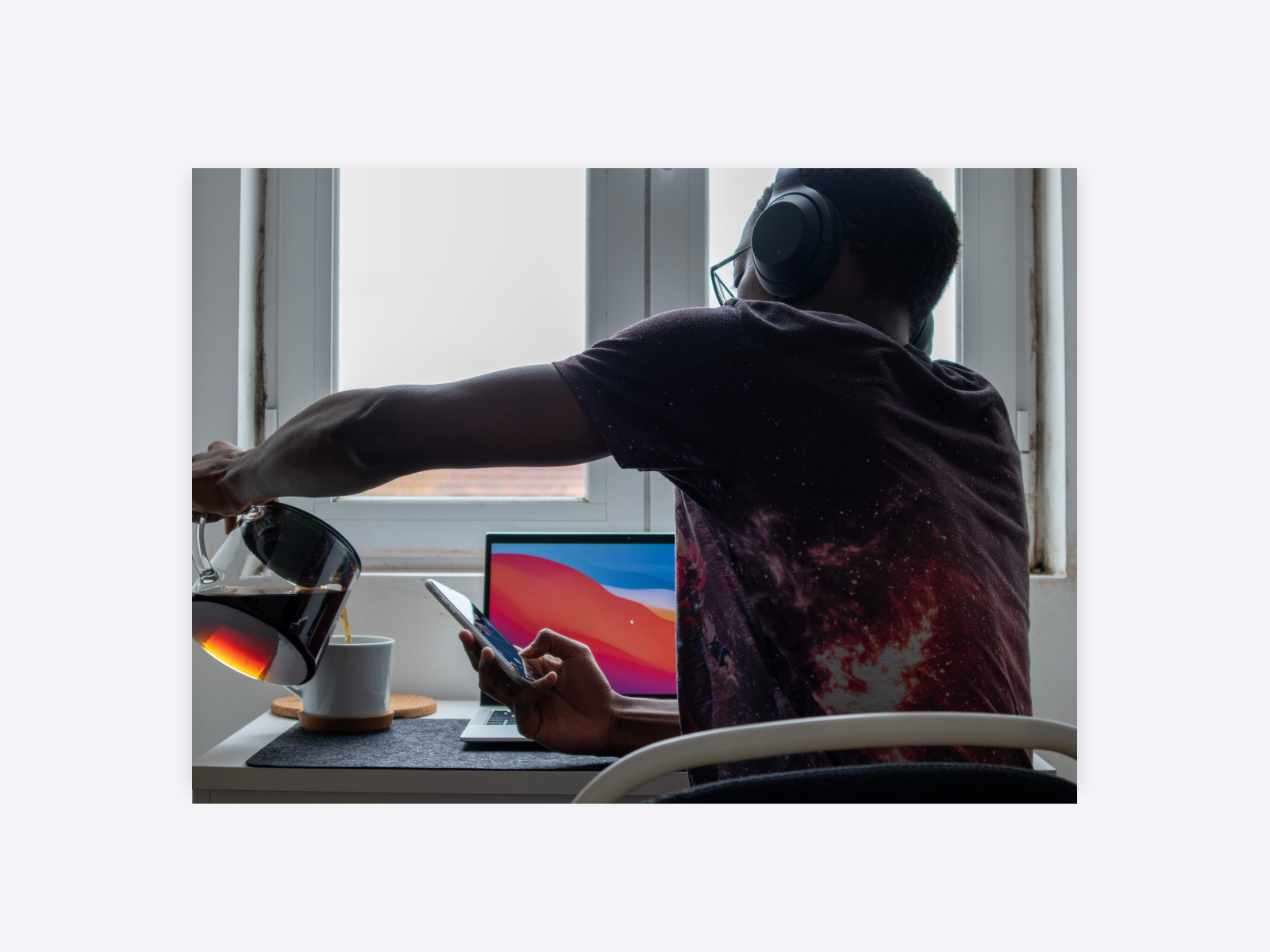 A designer pouring himself a pot of coffee, ready to continue work.