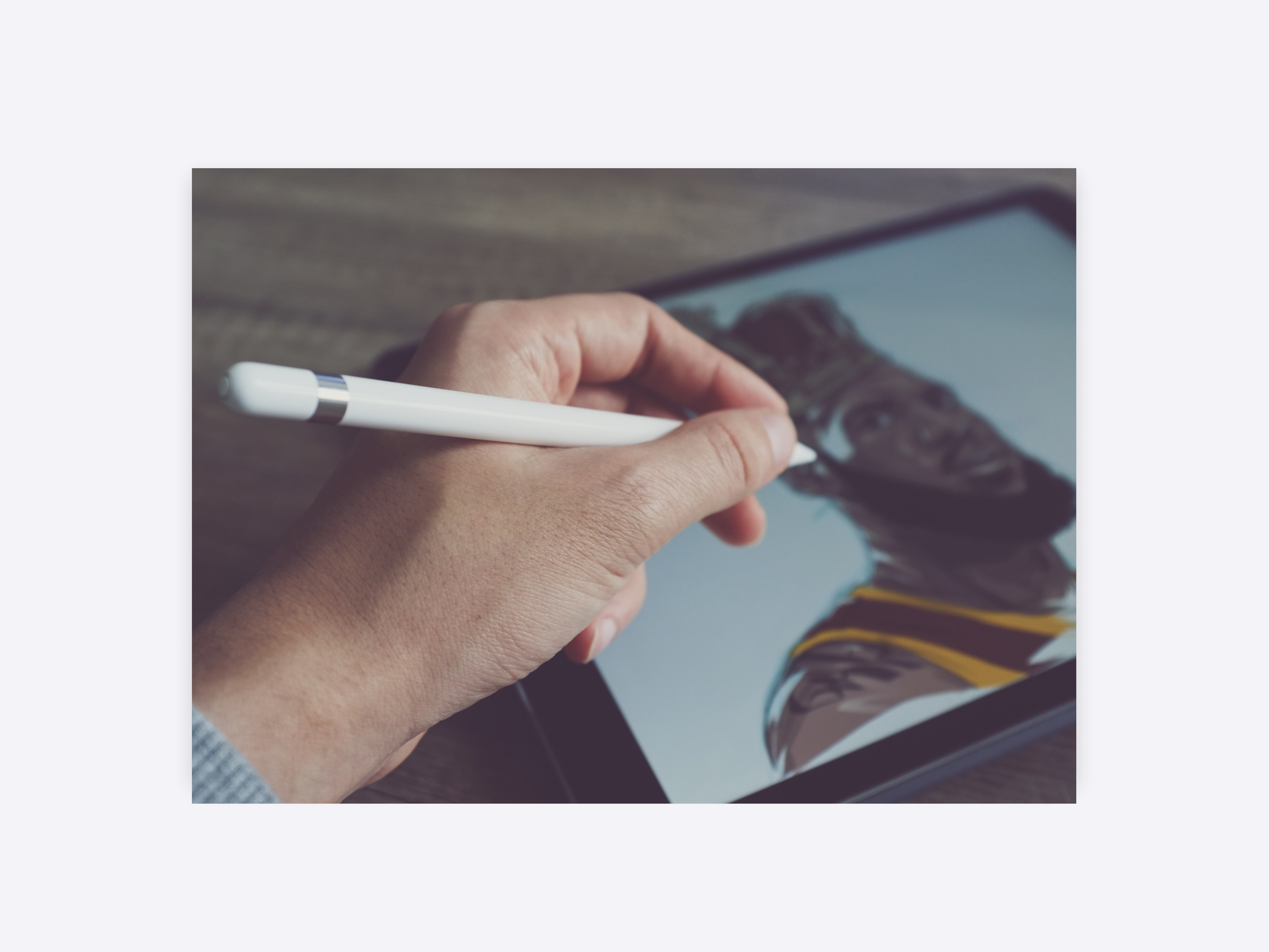 A digital artist drawing the portrait of a man in casual sports attire.