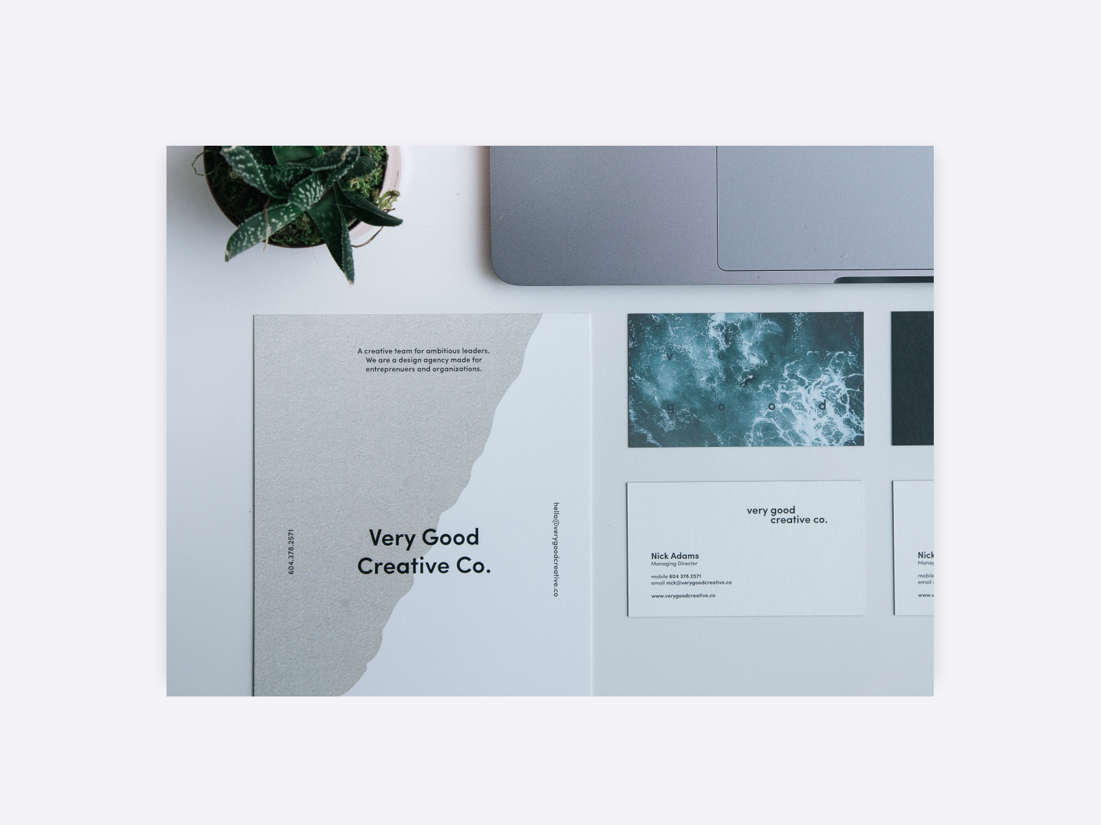 Branding design work for an imagined company including a letter set and business card with muted beige paper and photos of the ocean.