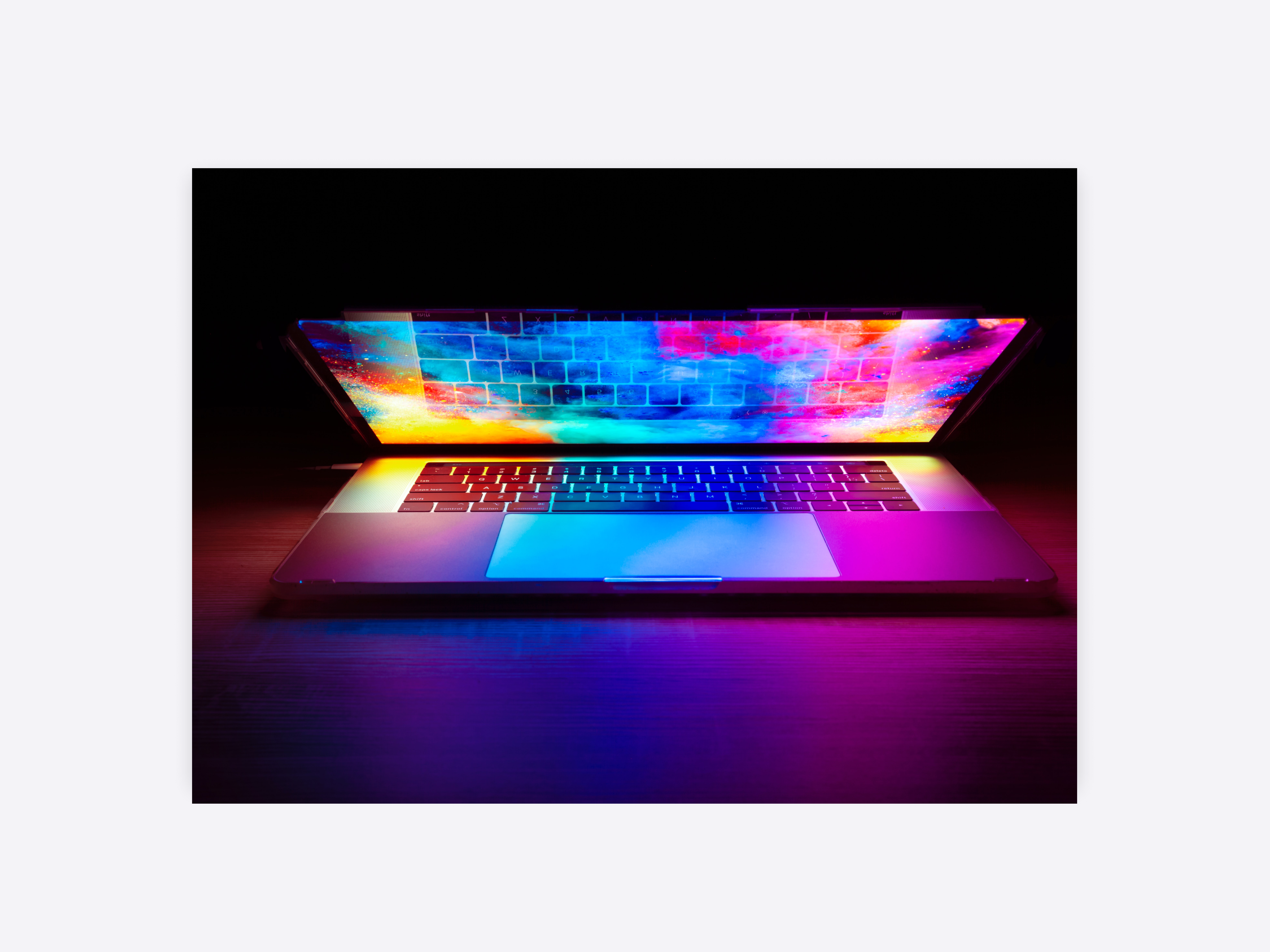 A laptop with a bright screen giving off a neon glow