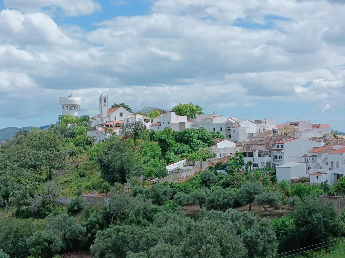 Whitewashed Algarve hilltop village seen from the Via Algarviana between Salir and Alte