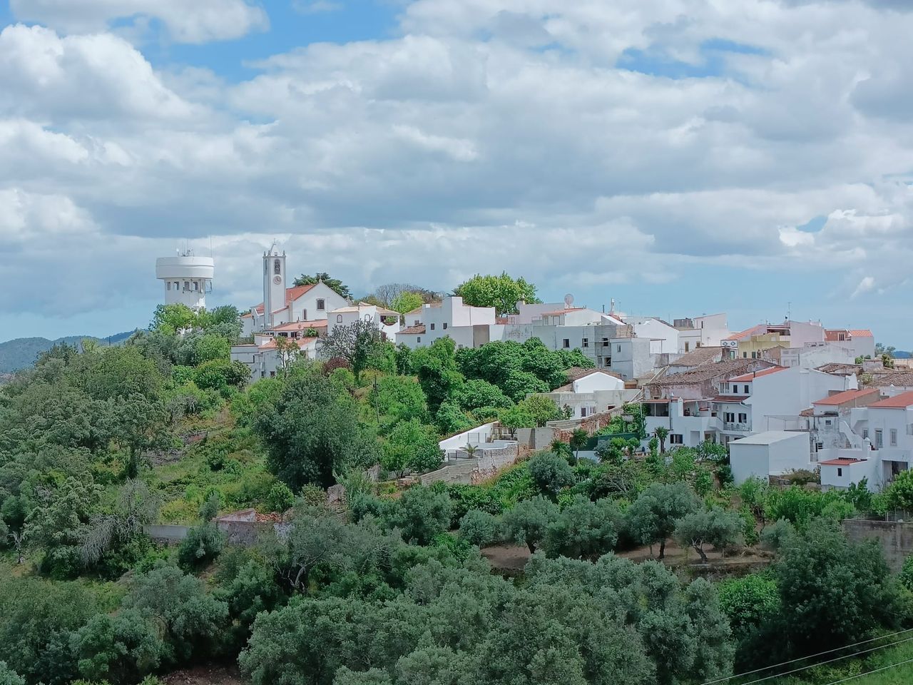 Whitewashed Algarve hilltop village seen from the Via Algarviana between Salir and Alte