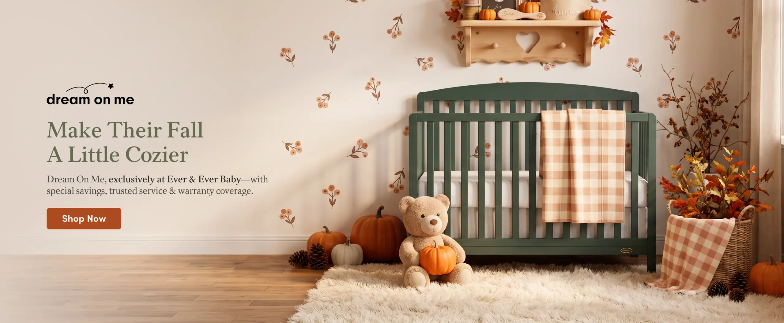 Fall nursery with green crib, teddy bear, pumpkins, and plaid blanket. Text: Make Their Fall A Little Cozier, Dream On Me.