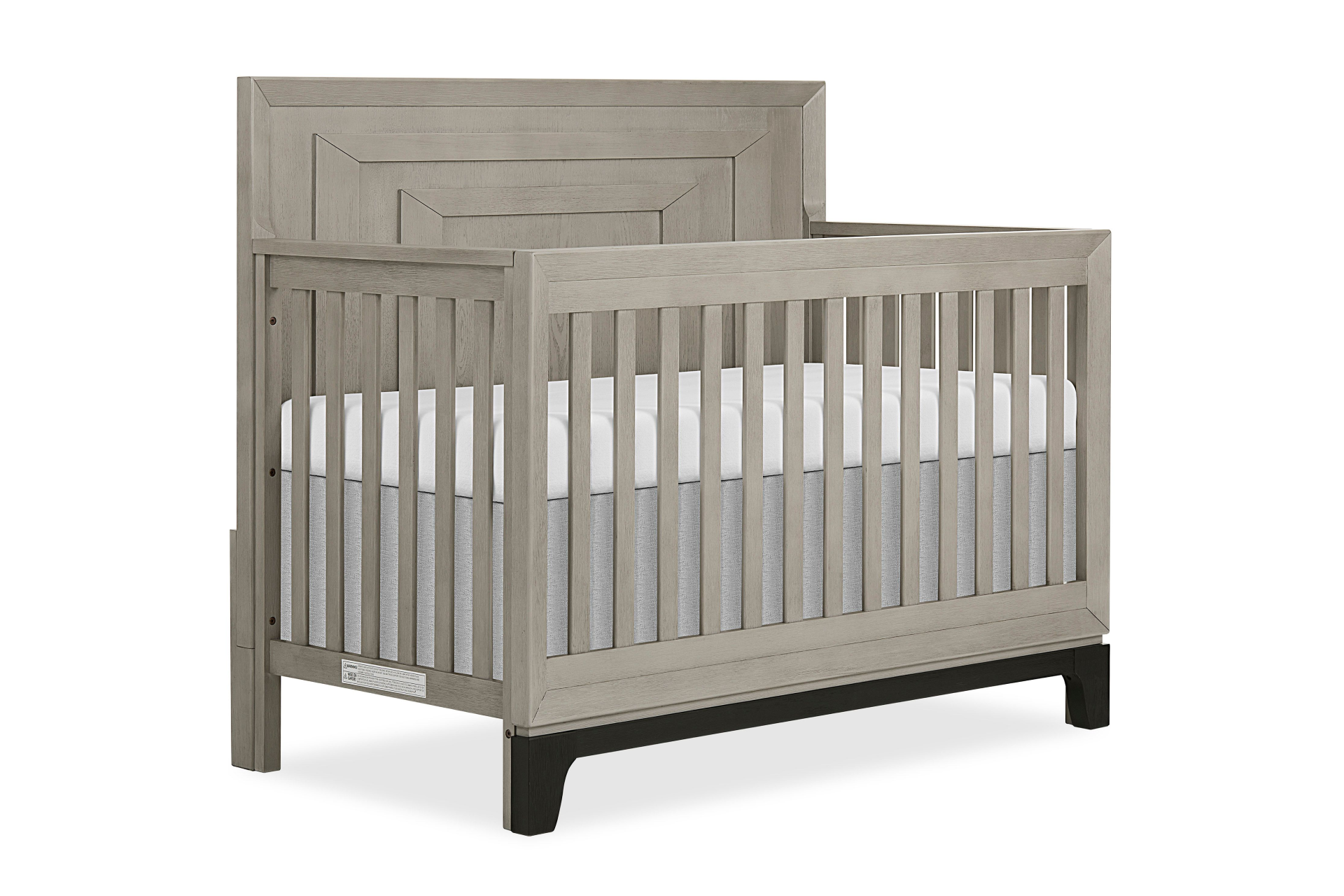 Evolur Remy Convertible Crib with paneled headboard, vertical slats, and black base legs, shown with a white mattress