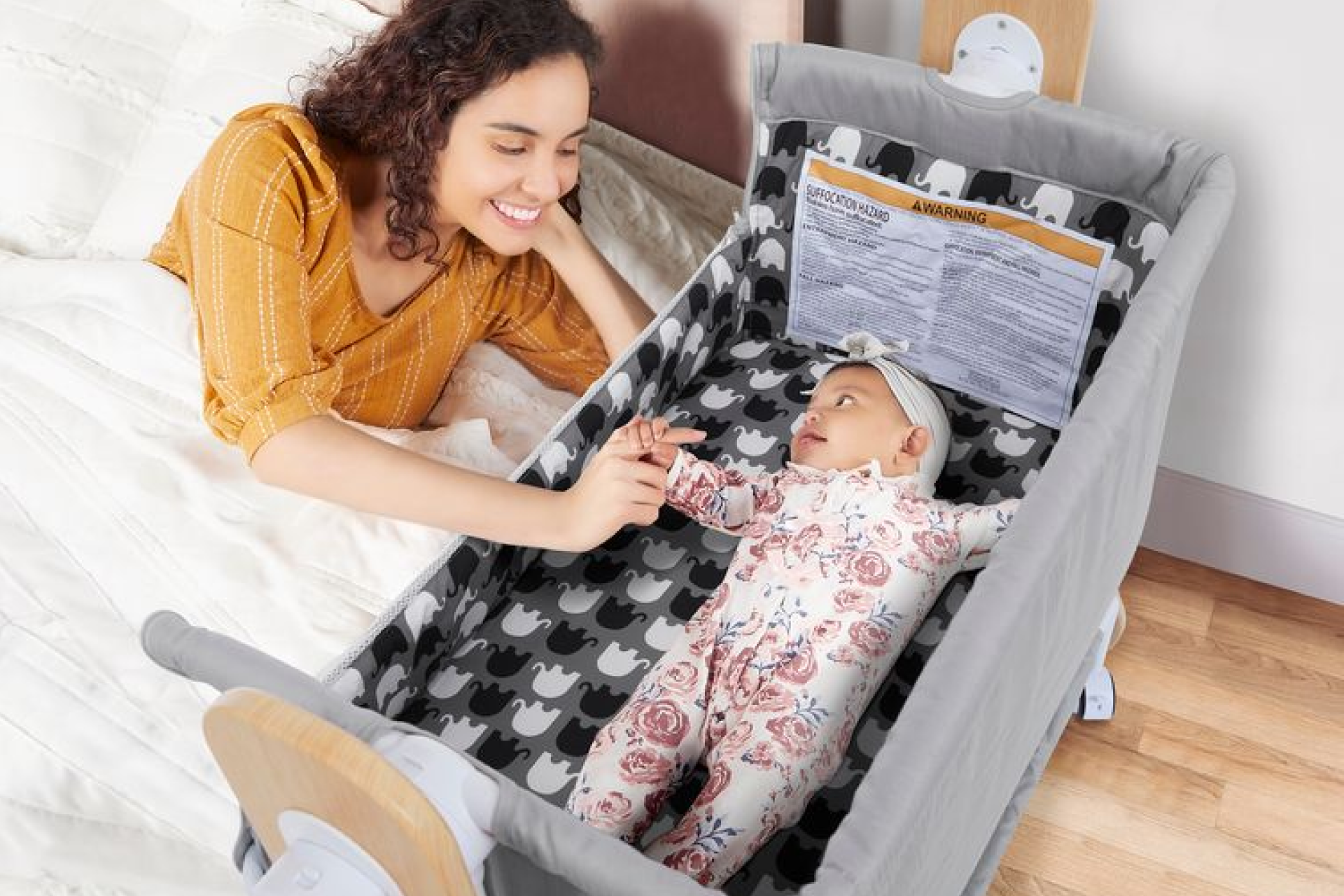 Dream On Me Horton Bassinet and Bedside sleeper attached to a bed, perfect for late-night feedings