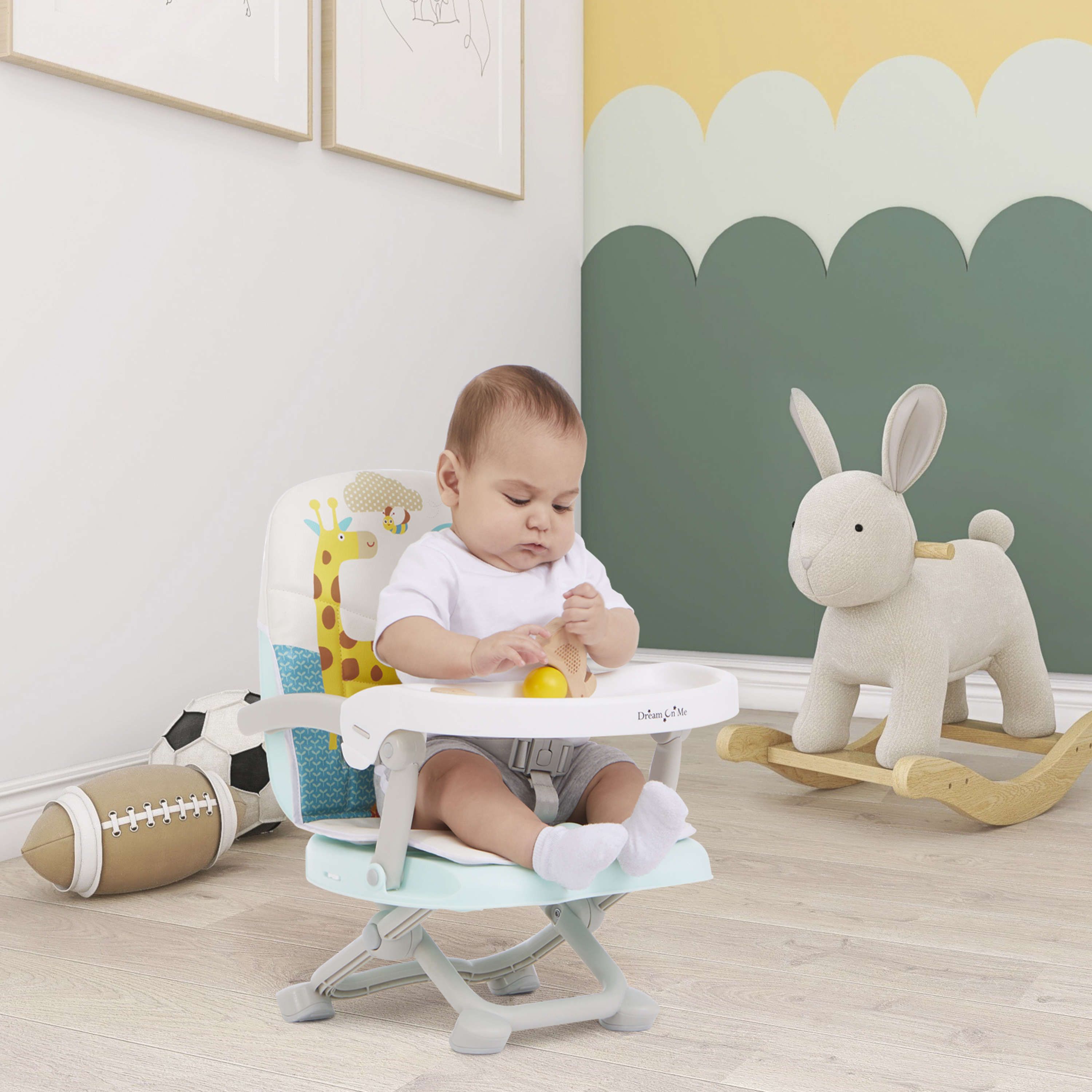 Baby seated in a high chair playing with a toy in a calm nursery