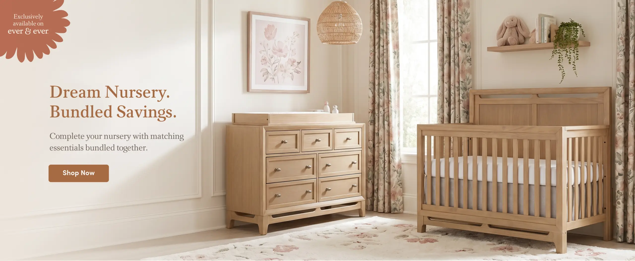 A light wood nursery with a crib and changing dresser, featuring promotional text "Dream Nursery. Bundled Savings."