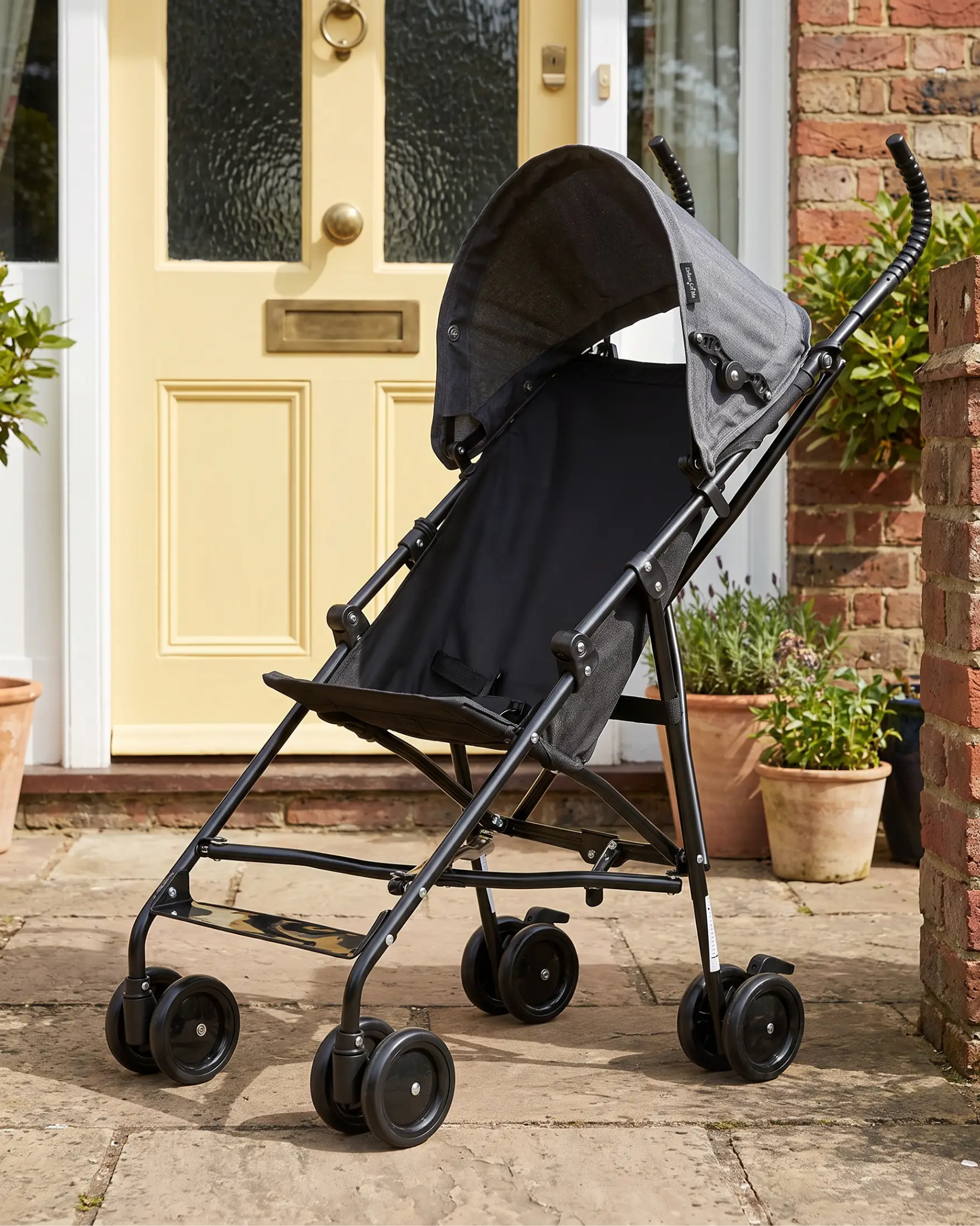 Black umbrella stroller with gray canopy.