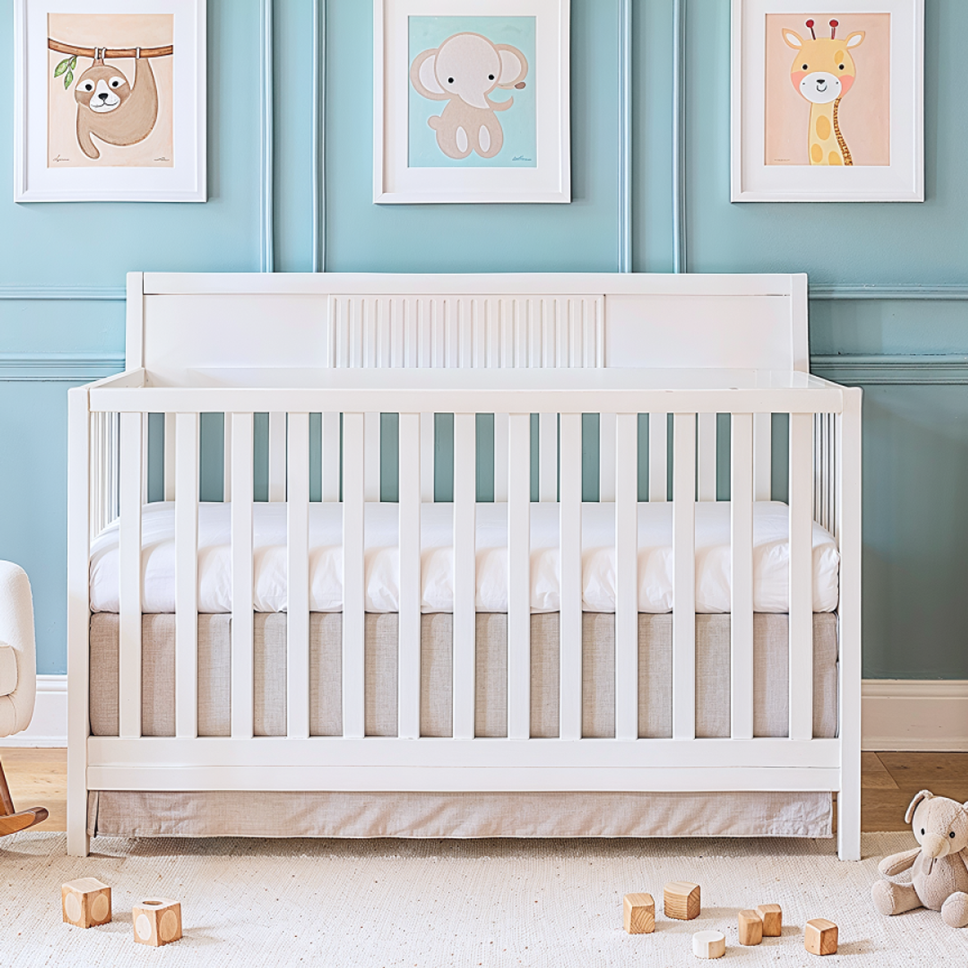 Dream On Me Ivy 5-in-1 Convertible crib in a playful nursery with teal walls, animal-themed wall art, wooden dresser, and cozy rocking chair