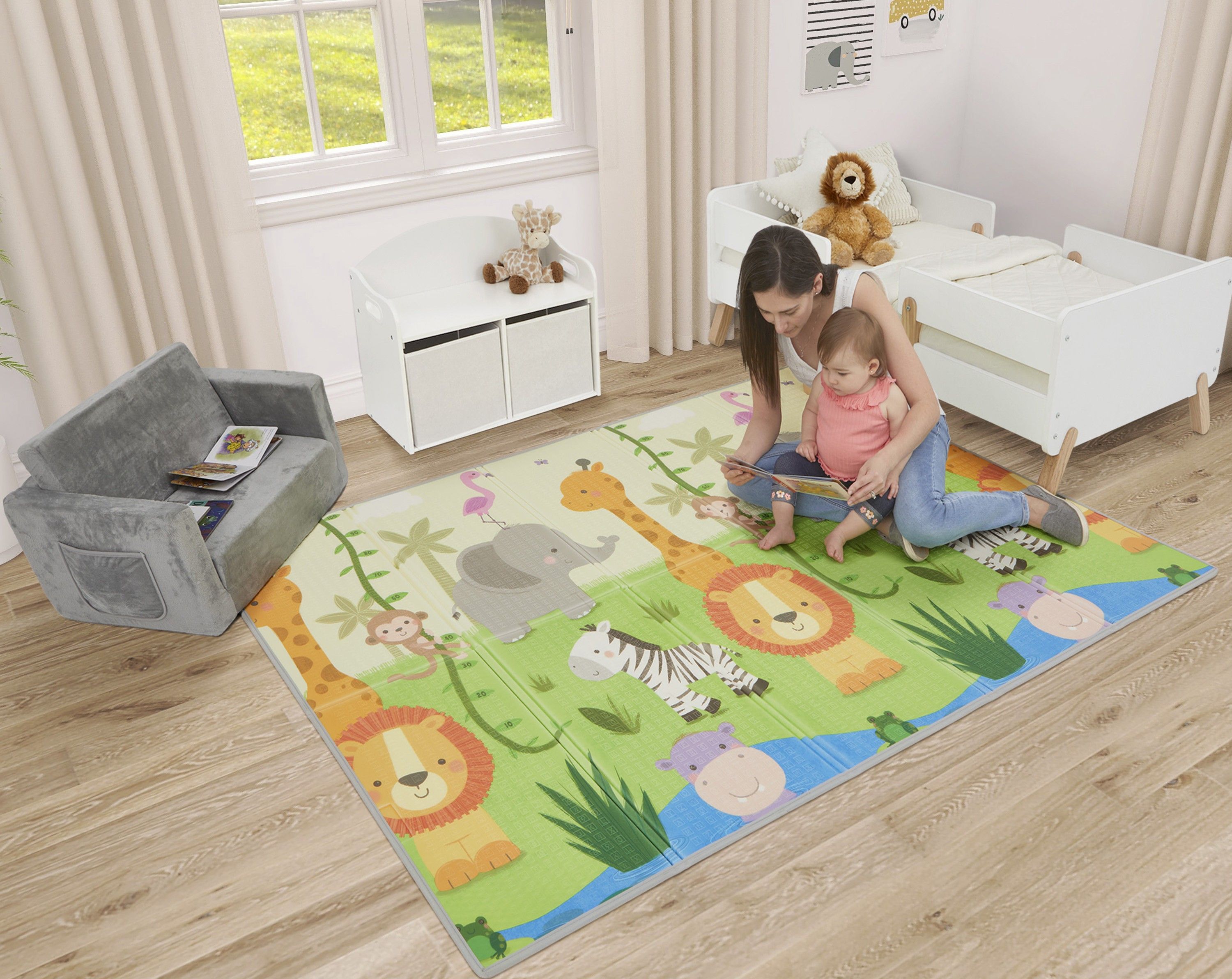 Dream On Me Play Time Reversible Baby Play Mat in a bright nursery, featuring a soft, foldable surface with colorful animal prints, where a mother sits with her baby for playtime and reading.