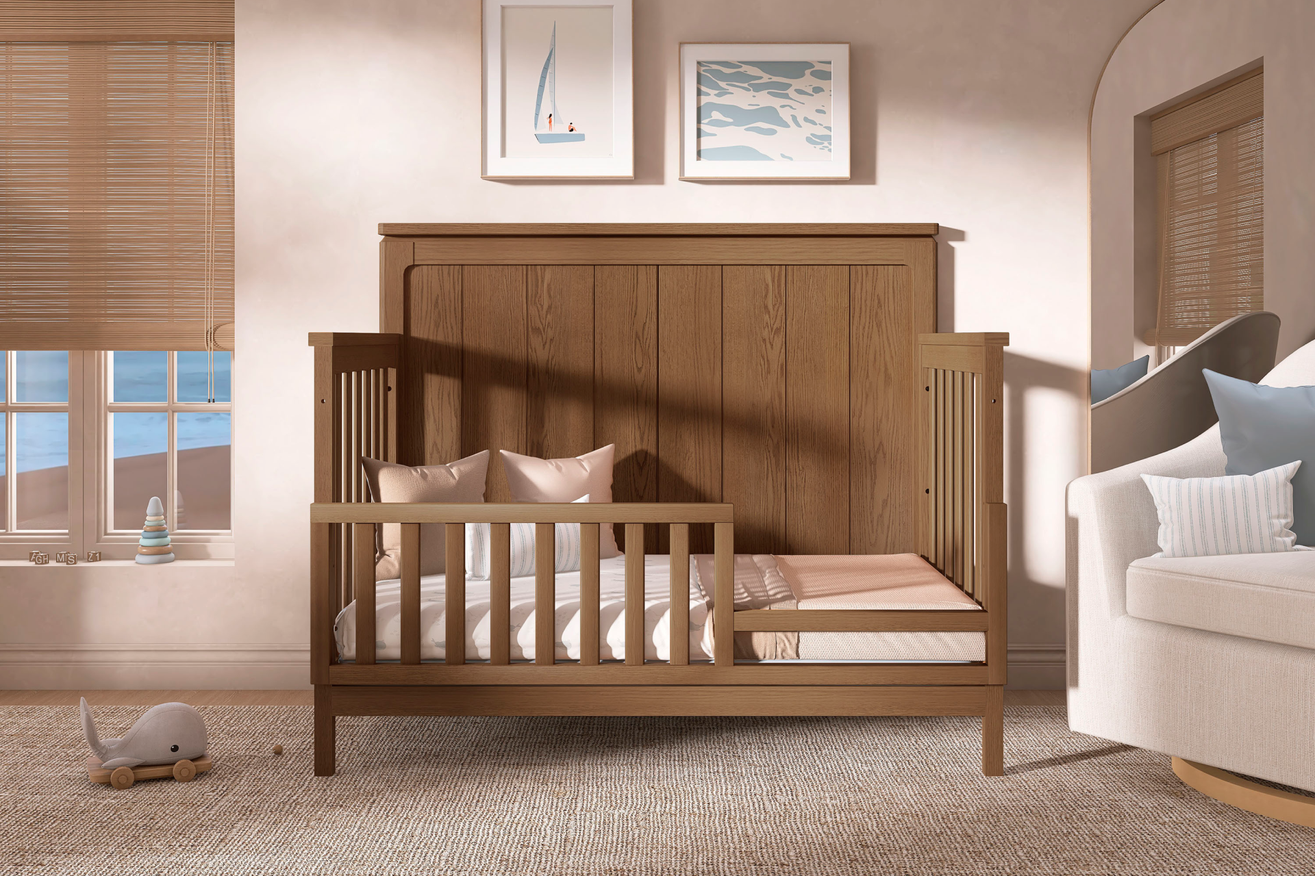 Evolur Oakley 5-in-1 Convertible Crib in a cozy, minimalist nursery with neutral tones and coastal wall art showcasing the crib convertibility to toddler bed