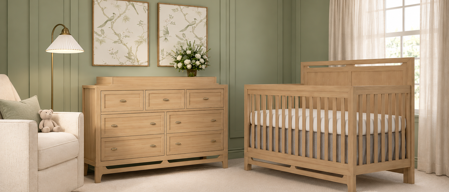 A serene sage green nursery with a natural wood crib, matching dresser with a changing top, and a cream glider.