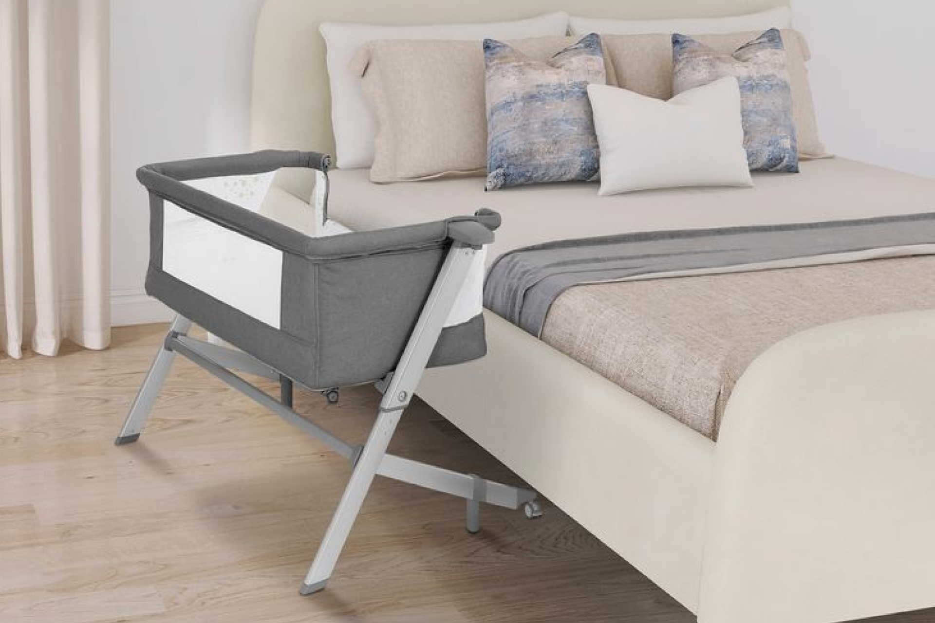 A sleek and modern Dream On Me Skylar Bassinet and Bedside Sleeper next to a bed