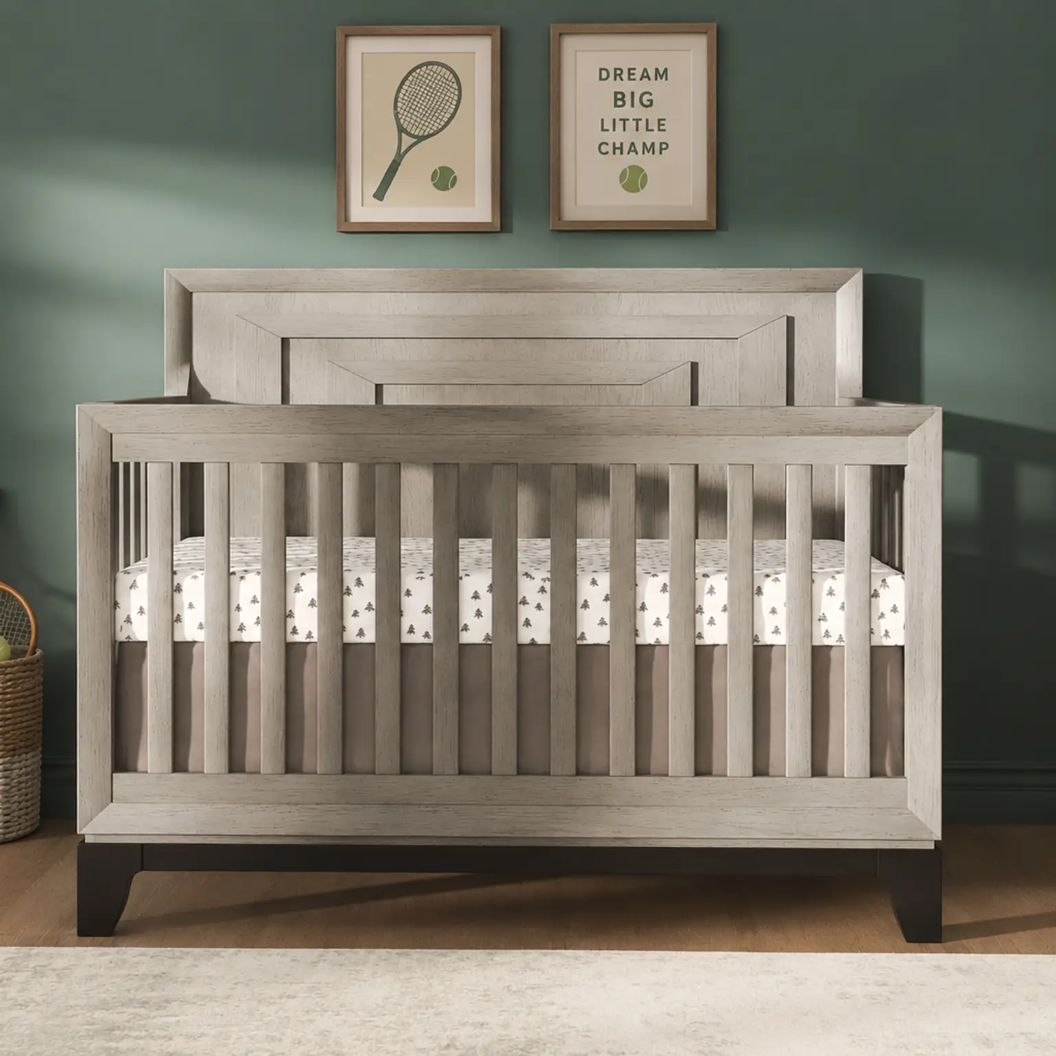 Modern grey crib in a nursery with dark green walls, tennis-themed decor, and matching dressers.