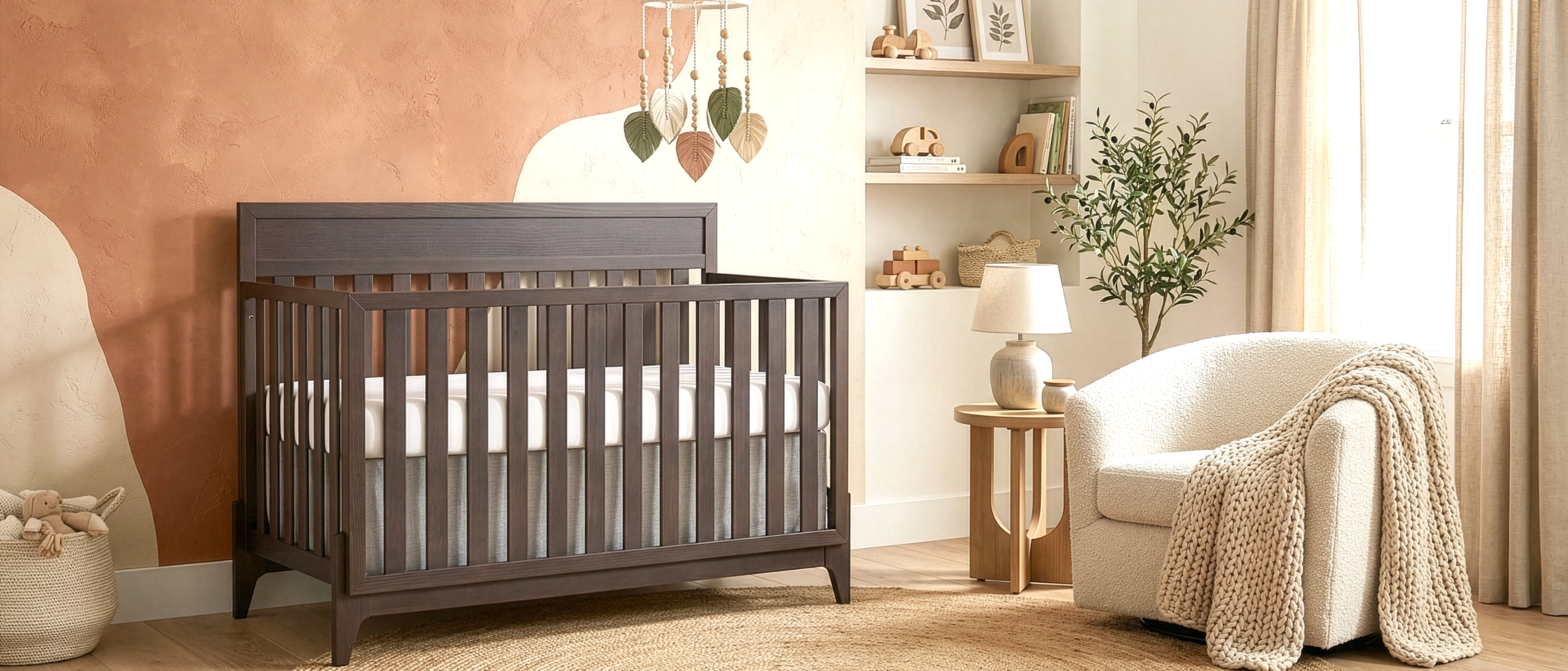 Modern baby nursery featuring Evolur Atlas 5-in-1 Convertible crib for multi-stage longevity, a textured rug, a cozy chair, and minimalist wall décor