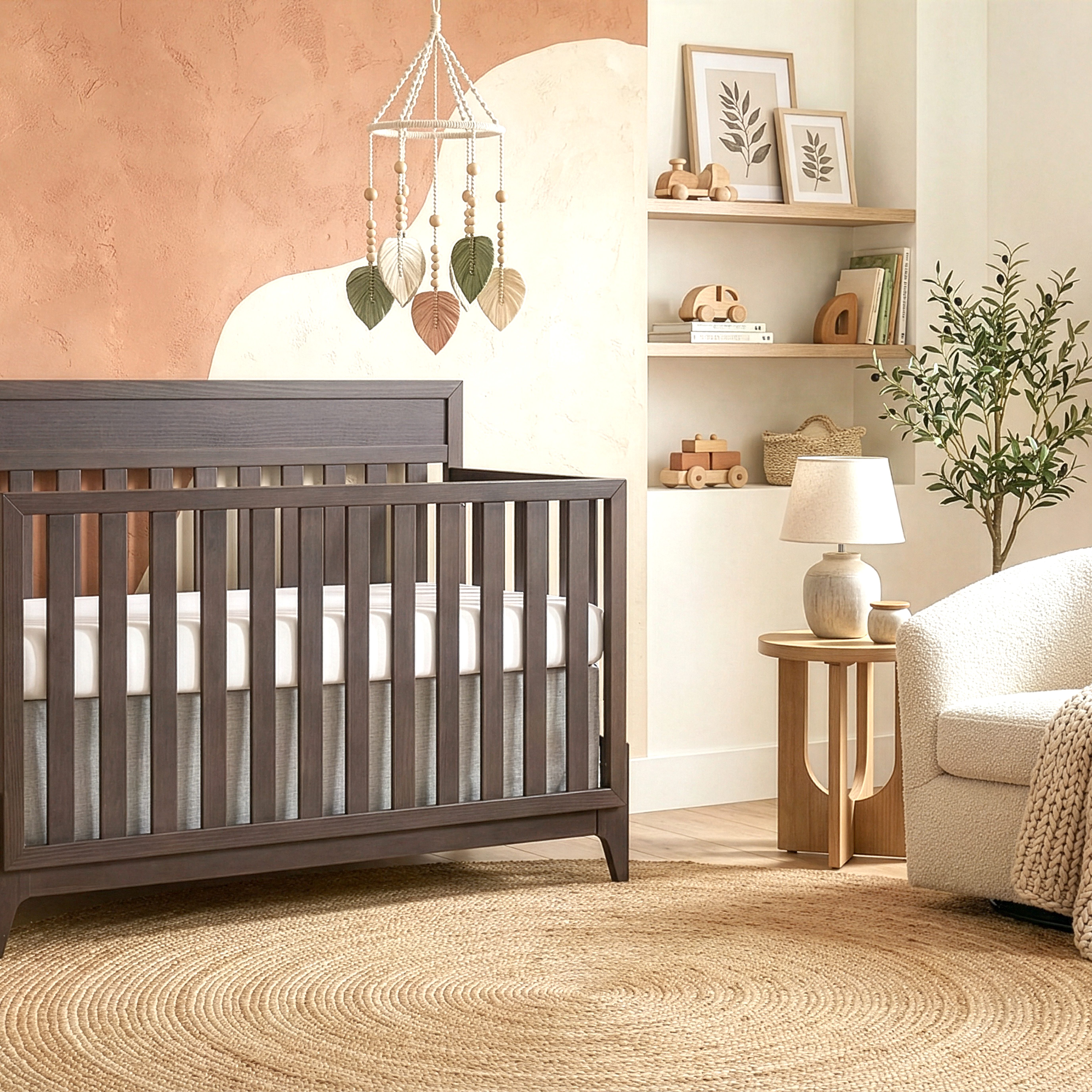 Modern baby nursery featuring Evolur Atlas 5-in-1 Convertible crib for multi-stage longevity, a textured rug, a cozy chair, and minimalist wall décor