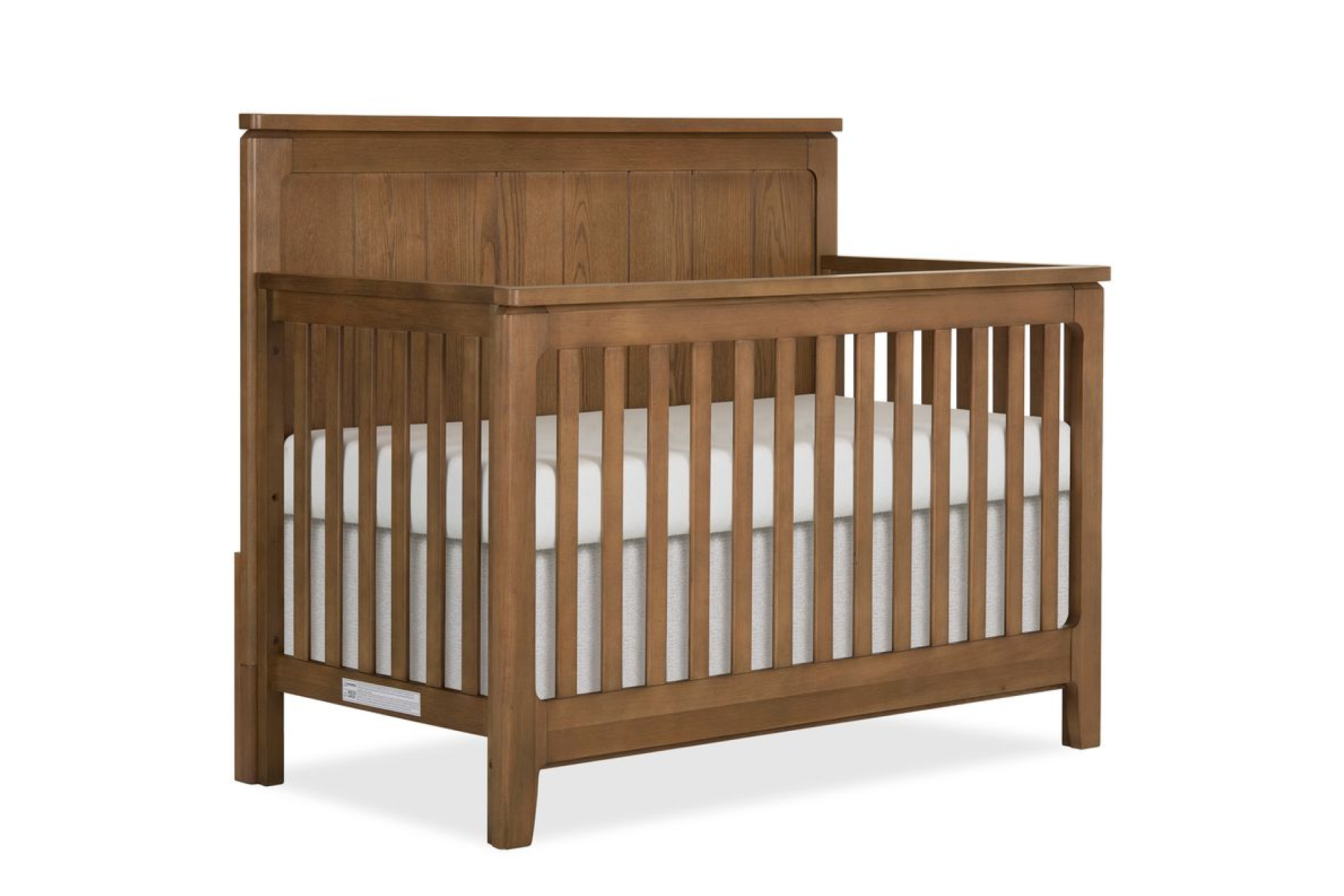 Evolur Oakley Crib with a paneled headboard and vertical slats, featuring a white mattress