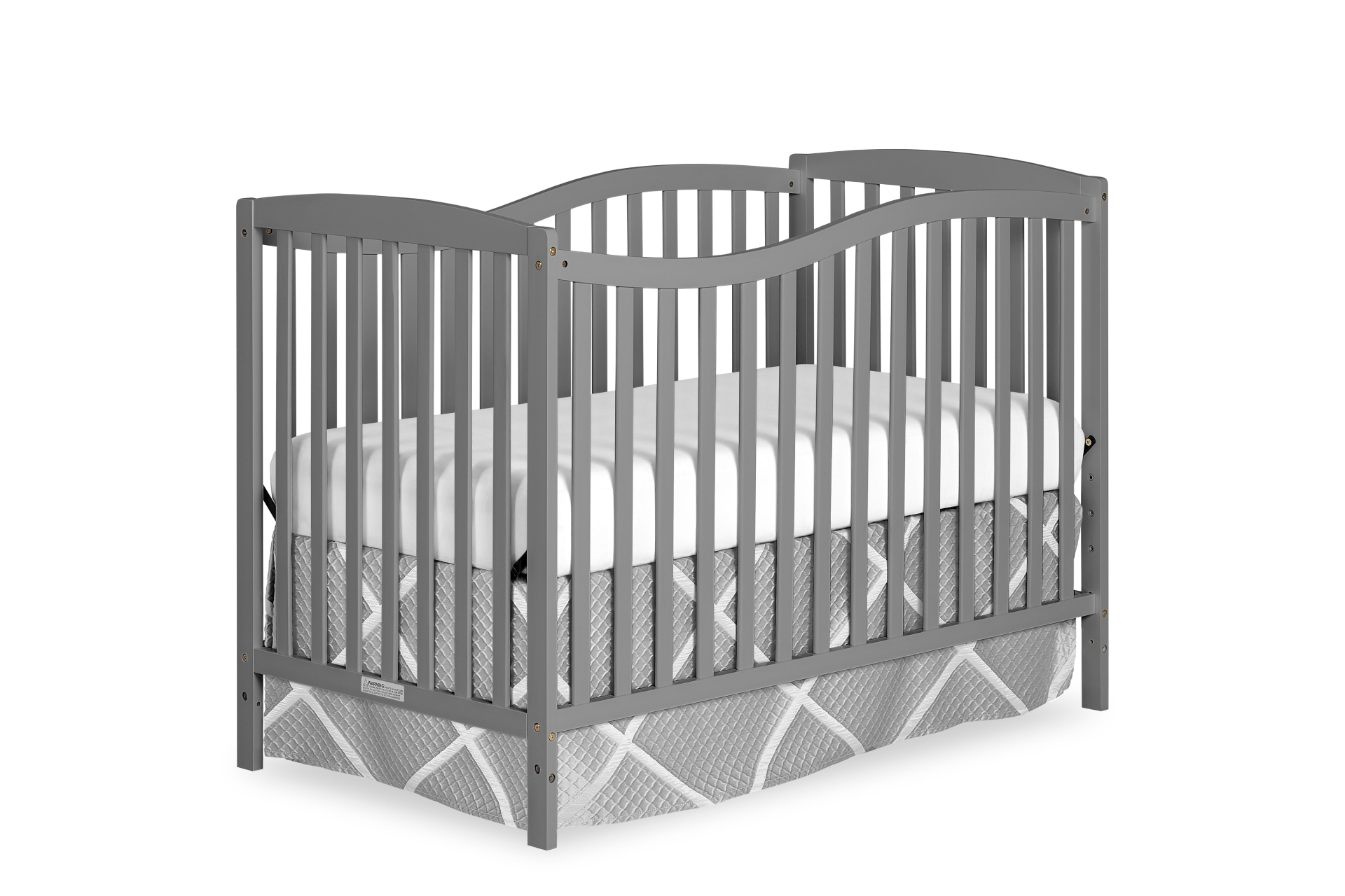 Dream On Me Chelsea crib with curved headboard and slatted sides, shown with a white mattress and quilted bed skirt.