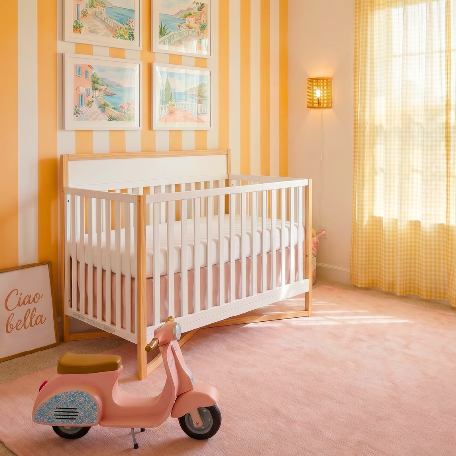 Dream On Me Owen 5-in-1 Convertible Crib in a bright nursery with striped walls, soft pink accents, and warm natural light
