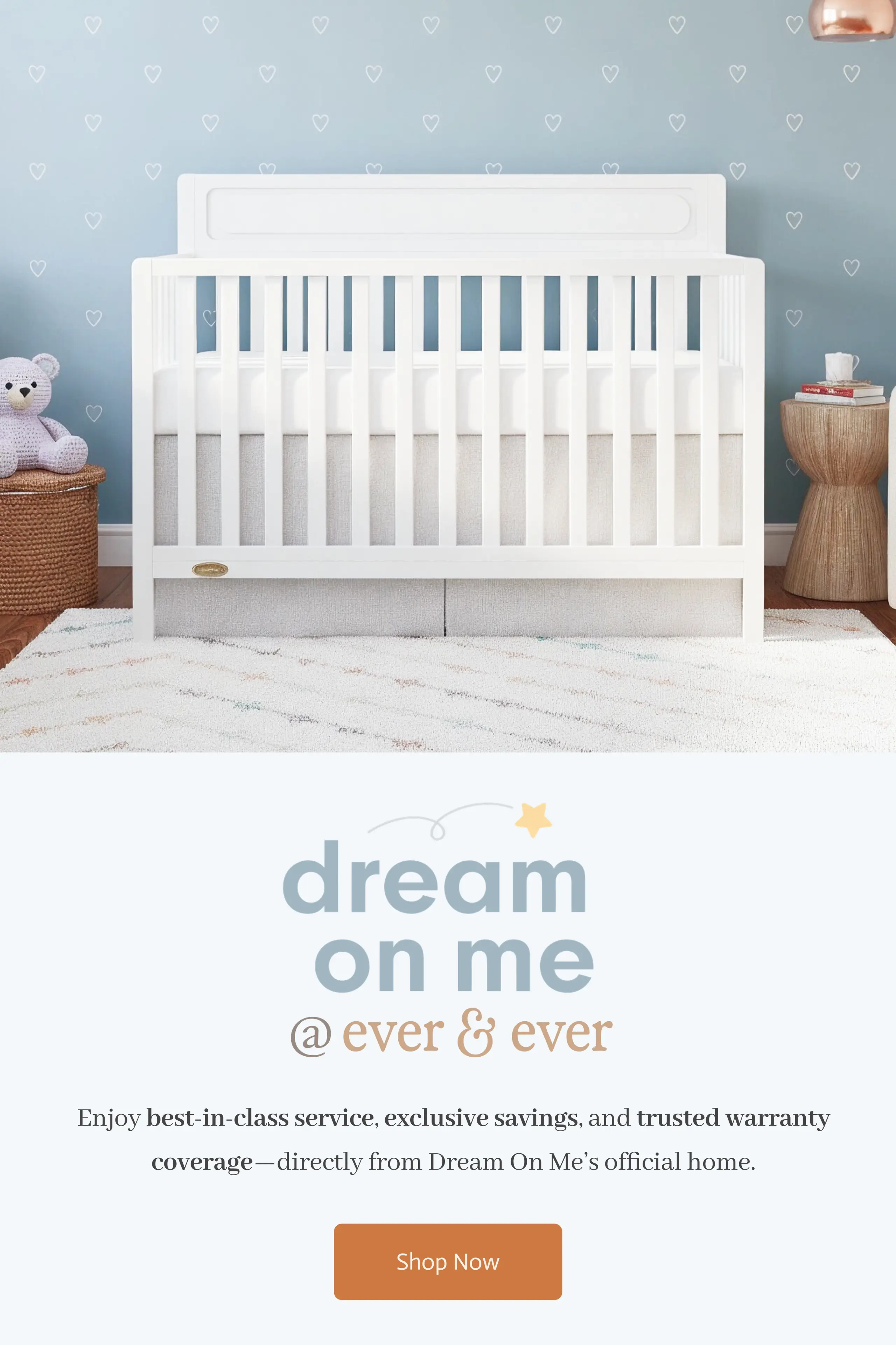 White crib in a nursery with blue heart walls and baby items, above a Dream On Me logo and "Shop Now" button.
