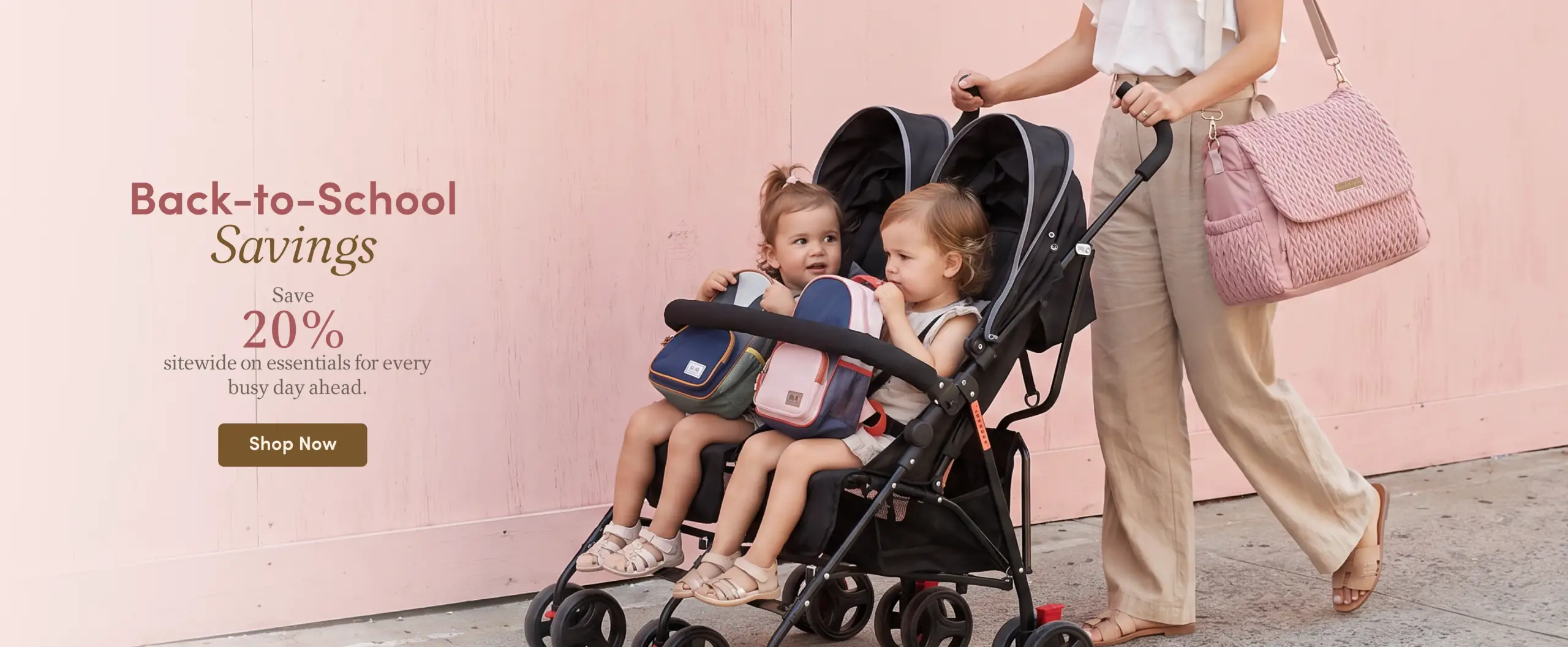 A woman pushes a double stroller with two toddlers holding mini backpacks, while she carries a large pink bag. Text overlay announces "Back-to-School Savings: Save 20%."