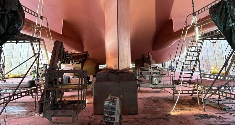 a large boat is being built in a warehouse .