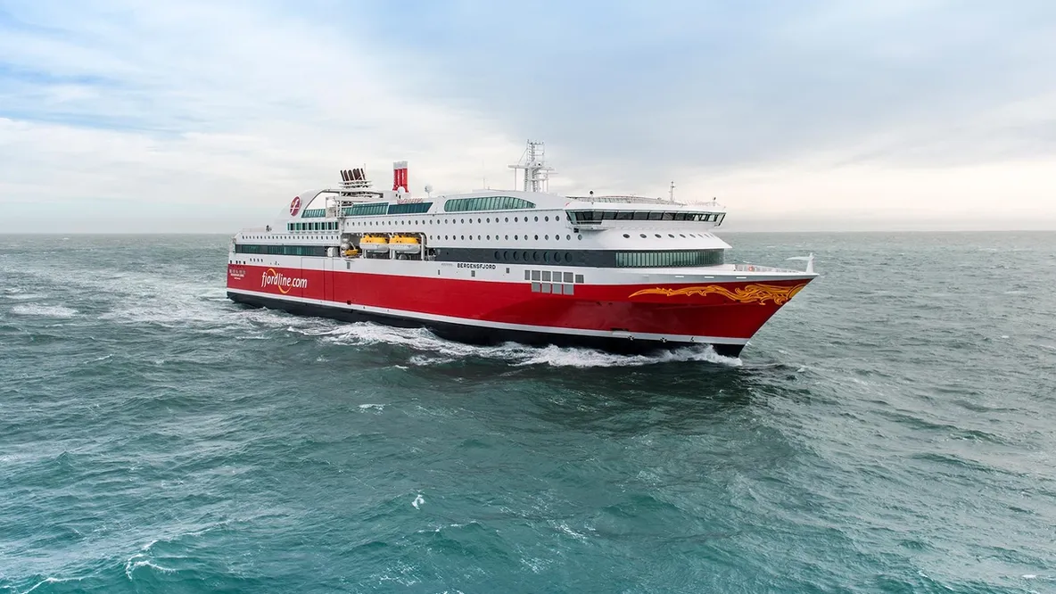 a large cruise ship is floating on top of a body of water .