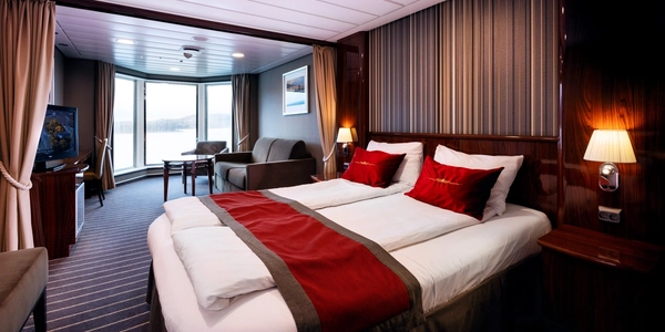 ein Hotelzimmer mit zwei Betten, einer Couch und einem Fernseher