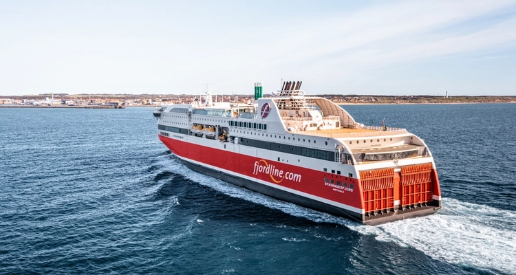 a large cruise ship is floating on top of a body of water .
