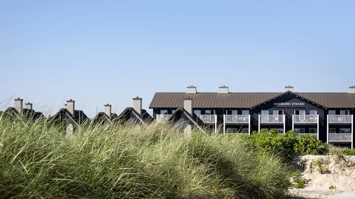 en husrekke på toppen av en sanddyne .