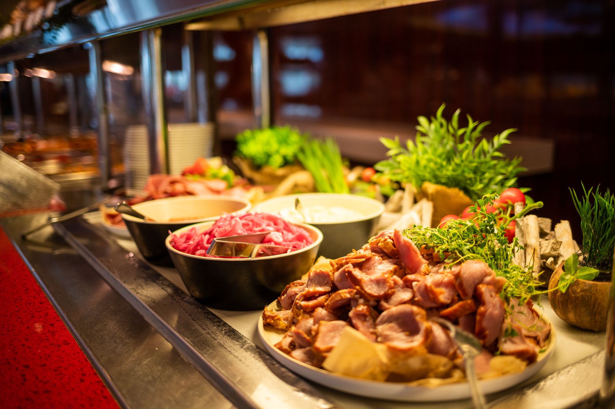 there are many different types of food on the buffet line .