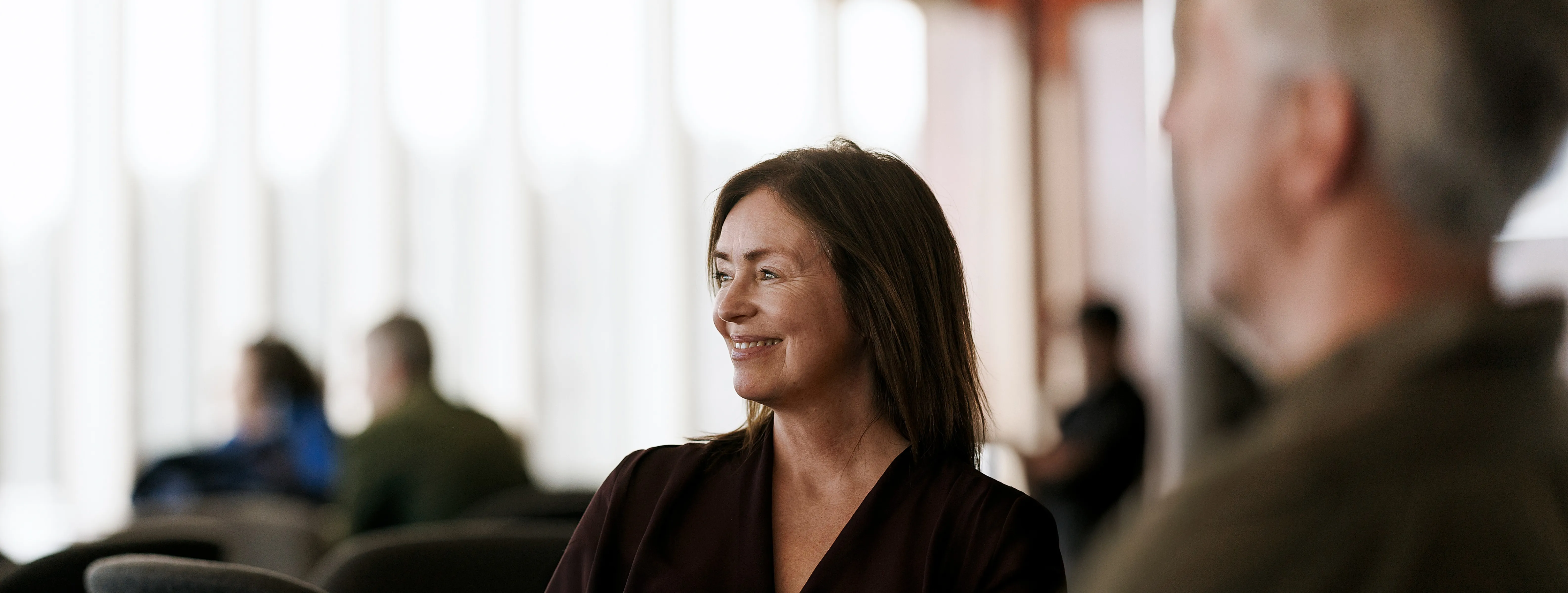 Woman in focus sitting in a bar