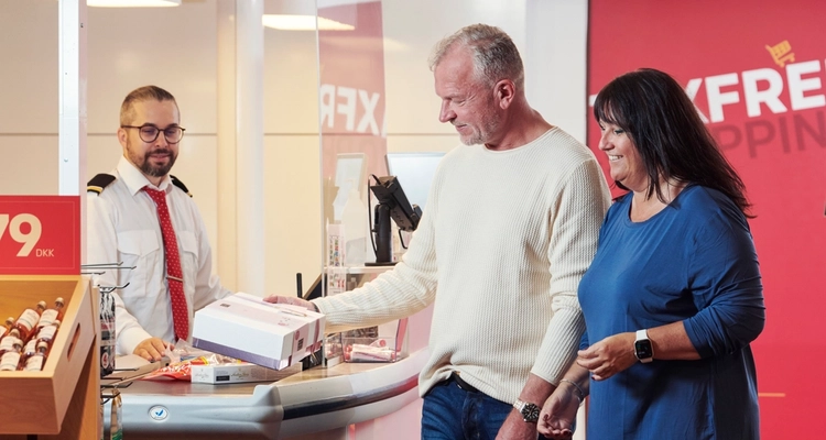 a man and a woman are standing in front of a cash register in a store .