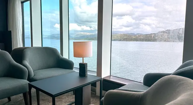 there is a large window with a view of the ocean .