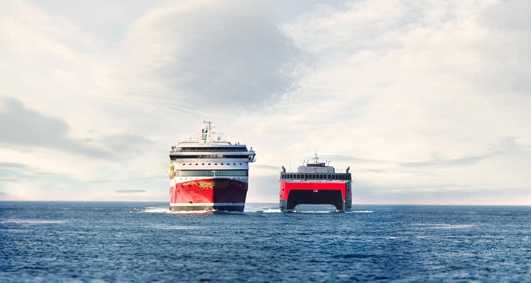two cruise ships are floating on top of a large body of water .