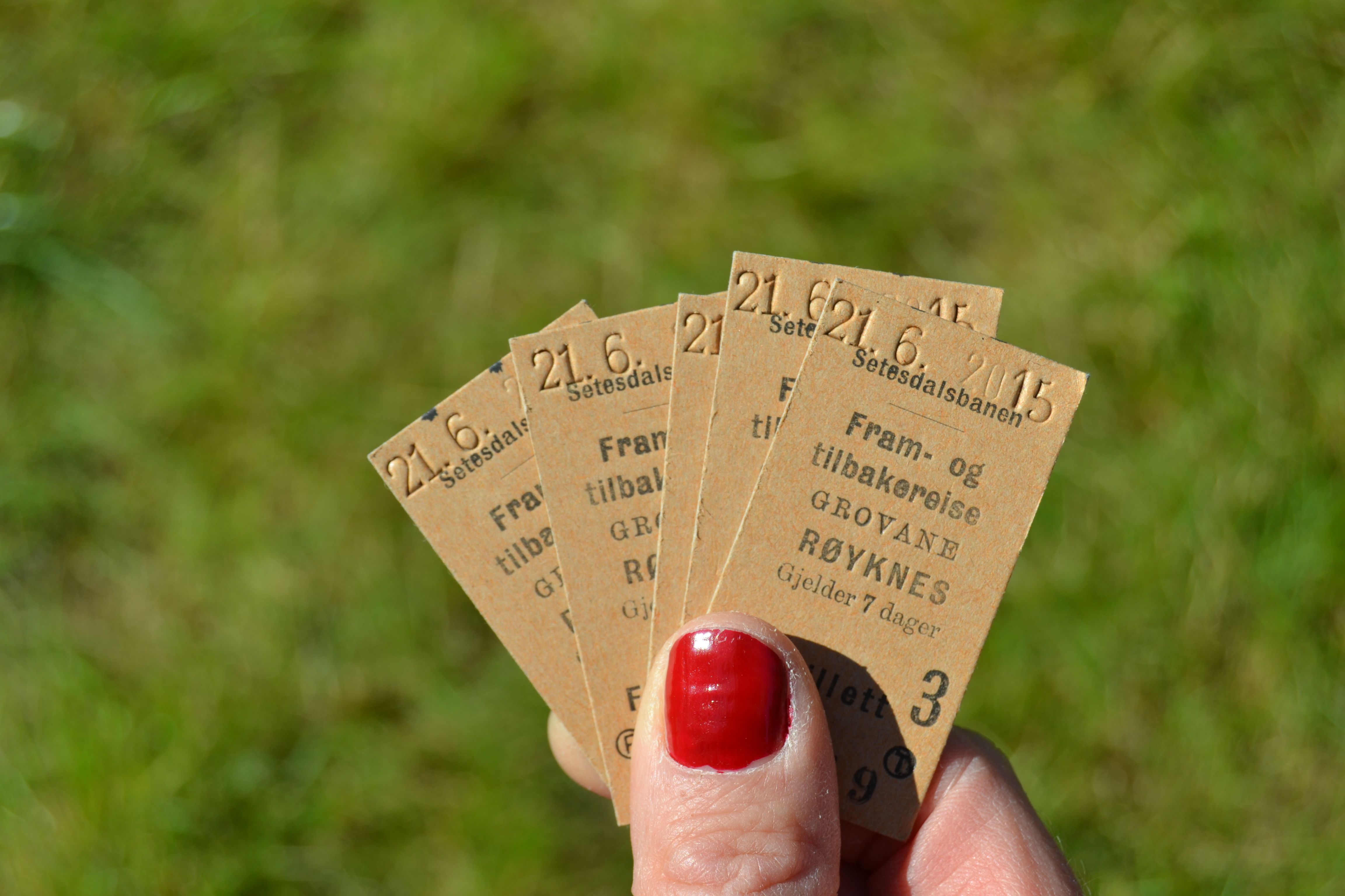 Hand holding old train tickets