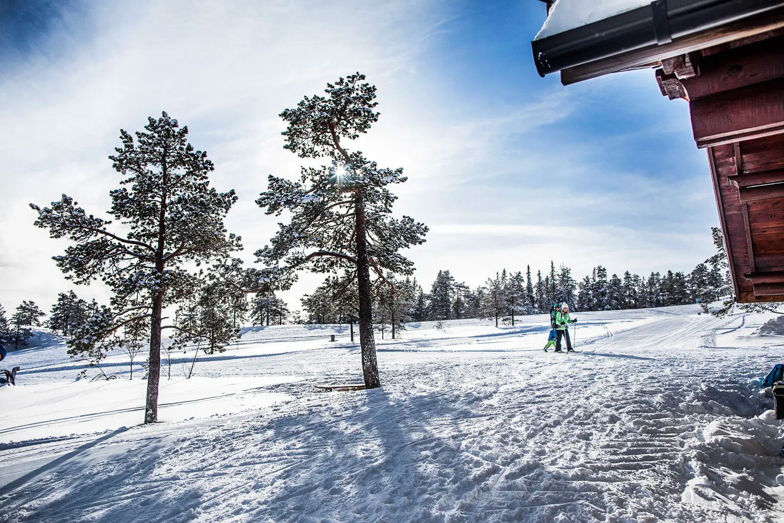a couple of people skiing down a snow covered slope