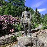 Statue with green surroundings and a pathway in the background