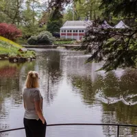 A lady stands and looks out over a body of water
