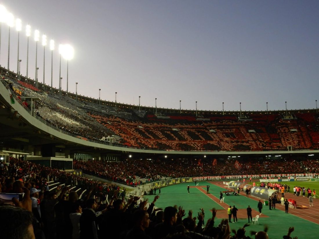 Großflächige rote, schwarze und gelbe Choreografie auf mehreren Tribünen des Stade du 5 Juillet.