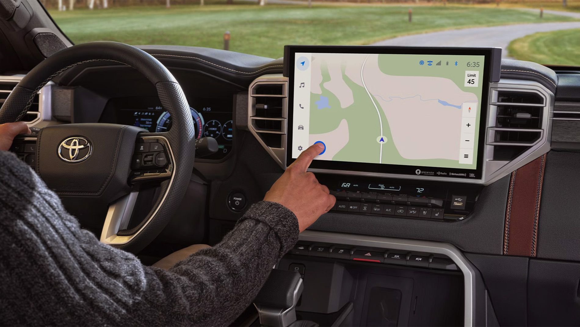 The interior of a toyota sequoia featuring brown leather seats and a large touchscreen display with navigation