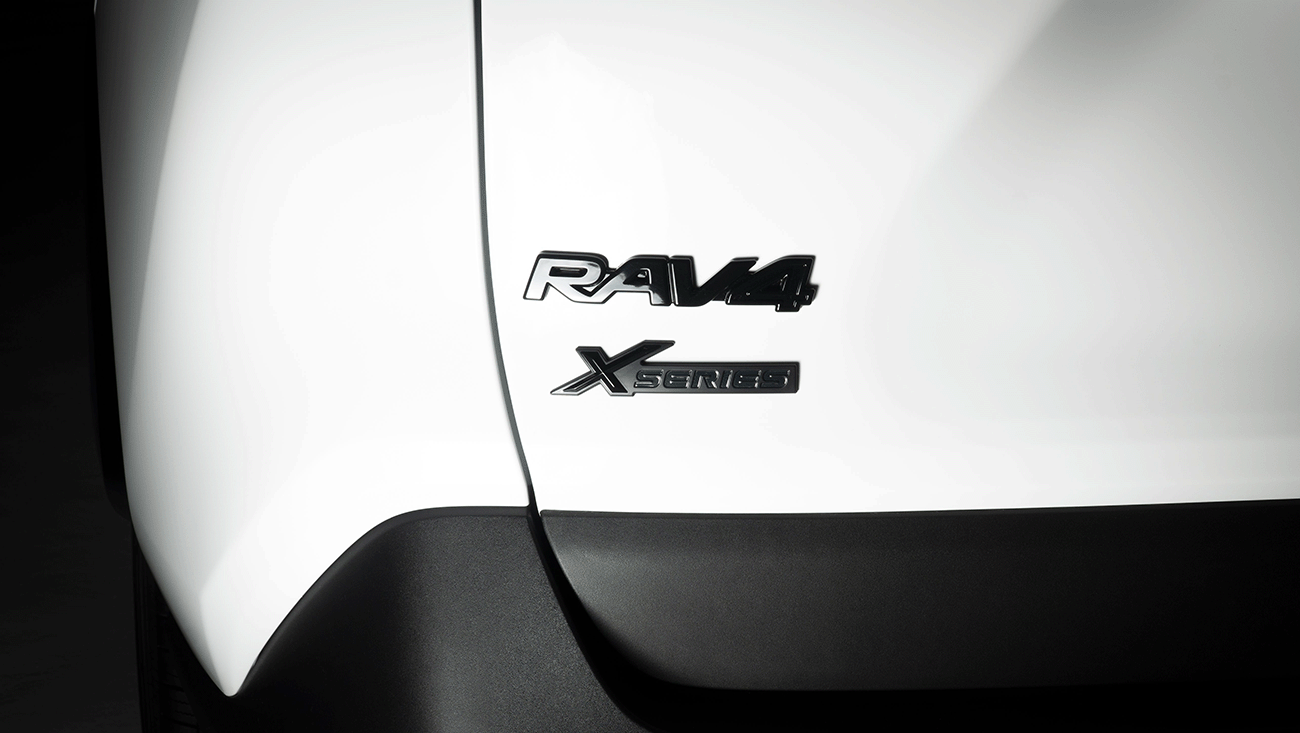 close up of a white Toyota RAV4 XP XSeries upgraded accessory package showing the upgraded black emblem