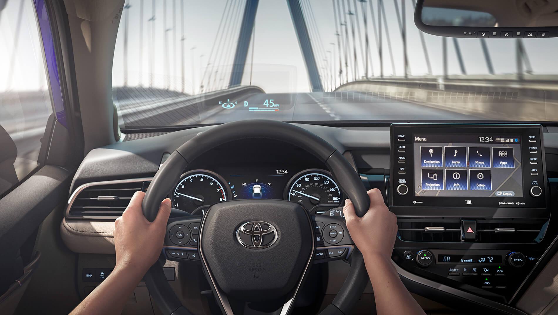 interior steering wheel and touch screen of a Toyota Camry