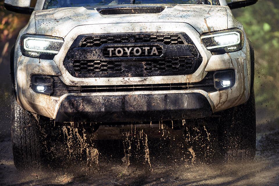 Toyota truck driving through the mud