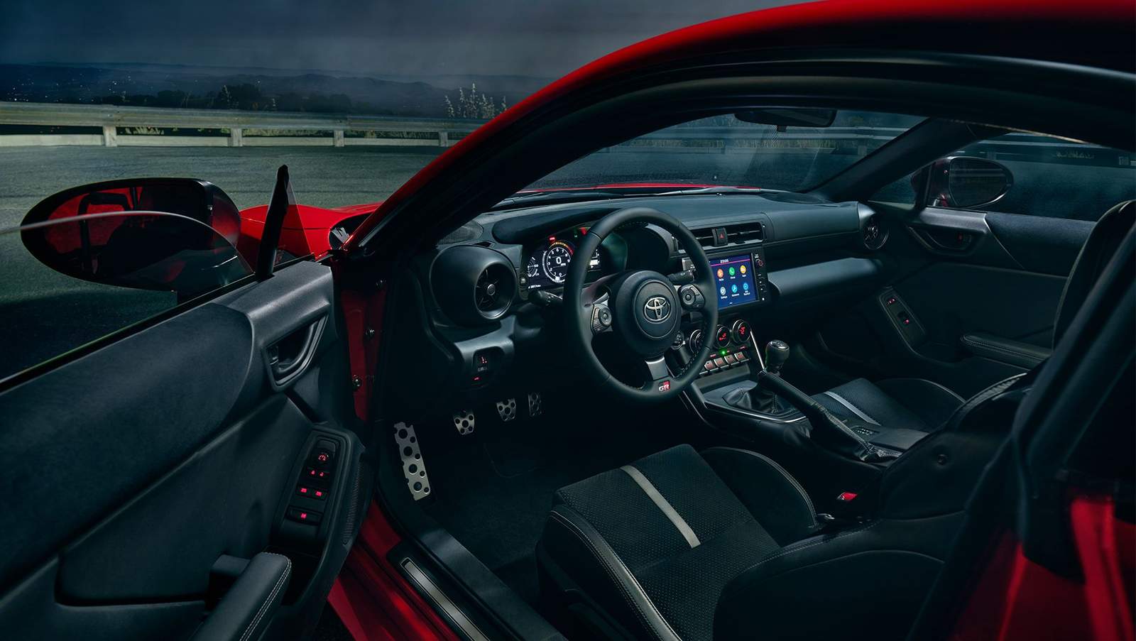 red 2024 Toyota GR86 sports car on track