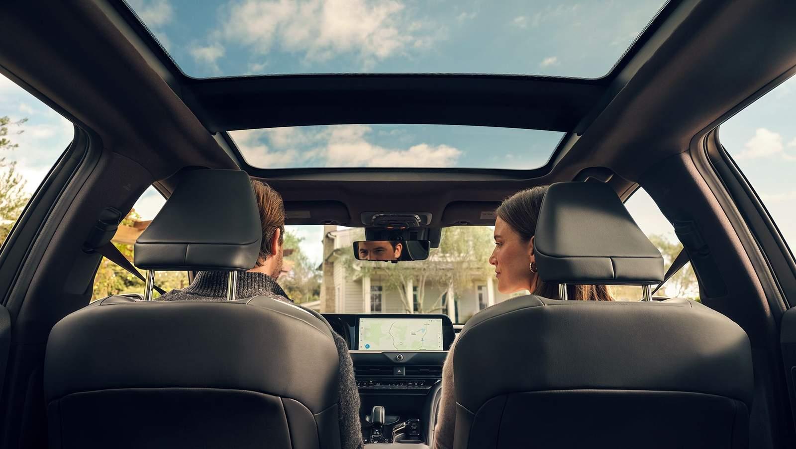 man and woman riding inside a Toyota Crown Signia