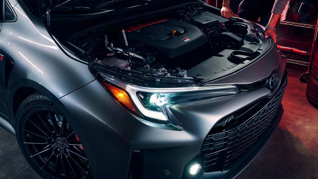 2024 Toyota GR Corolla with the hood open and the headlights on