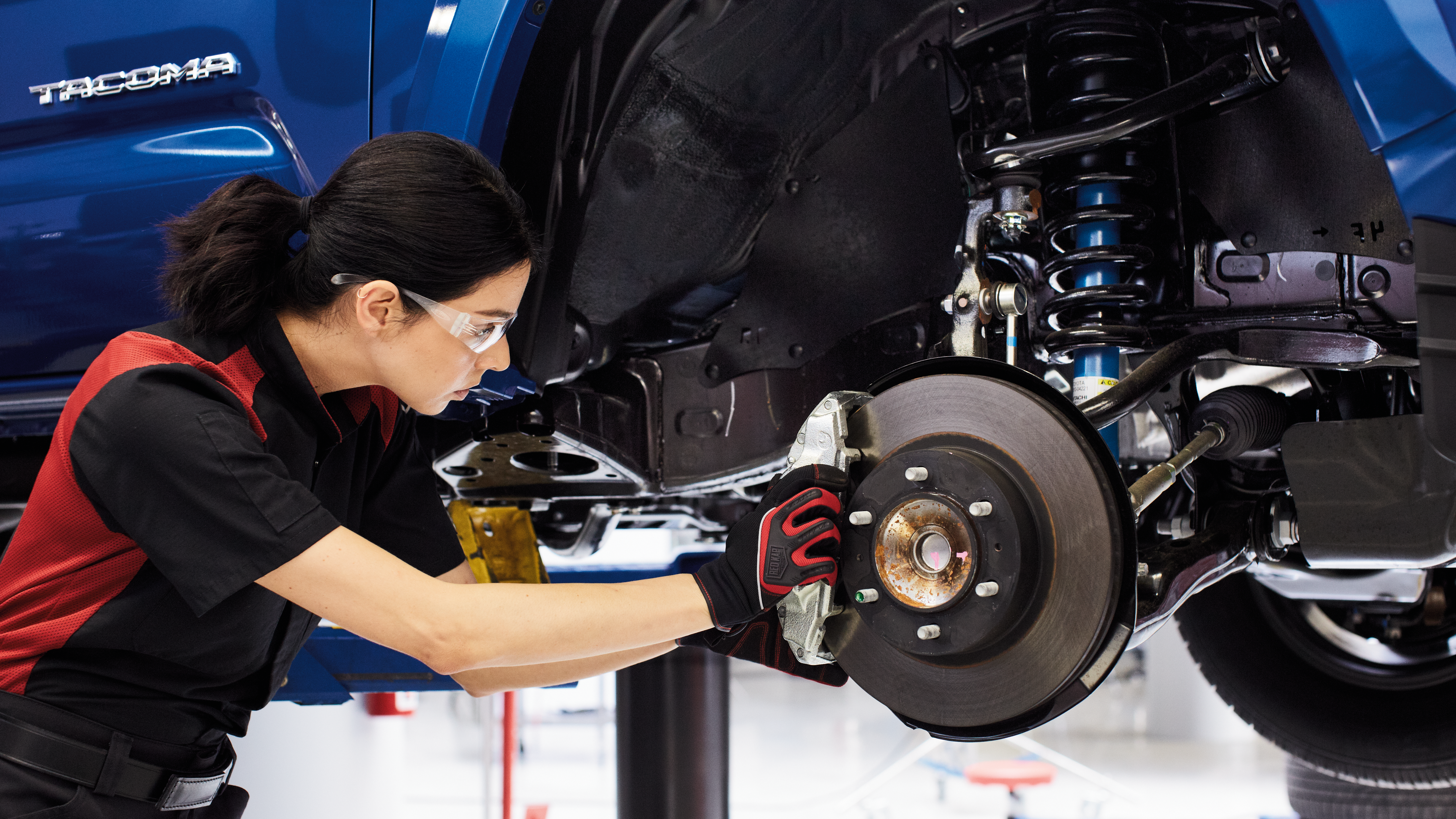 Toyota certified technician female changing brakes
