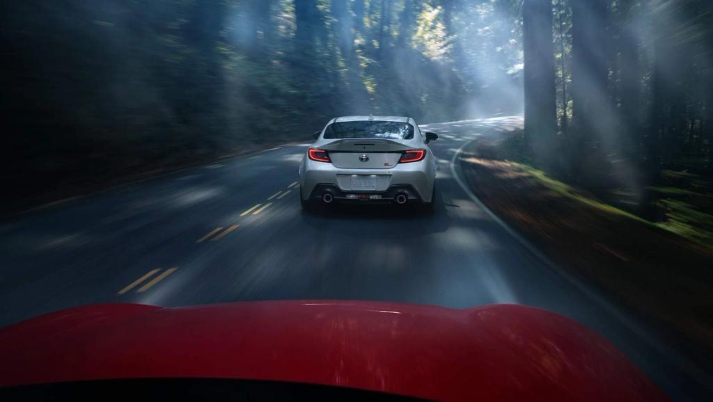 Toyota GR Supra driving down a windy deep mountain road