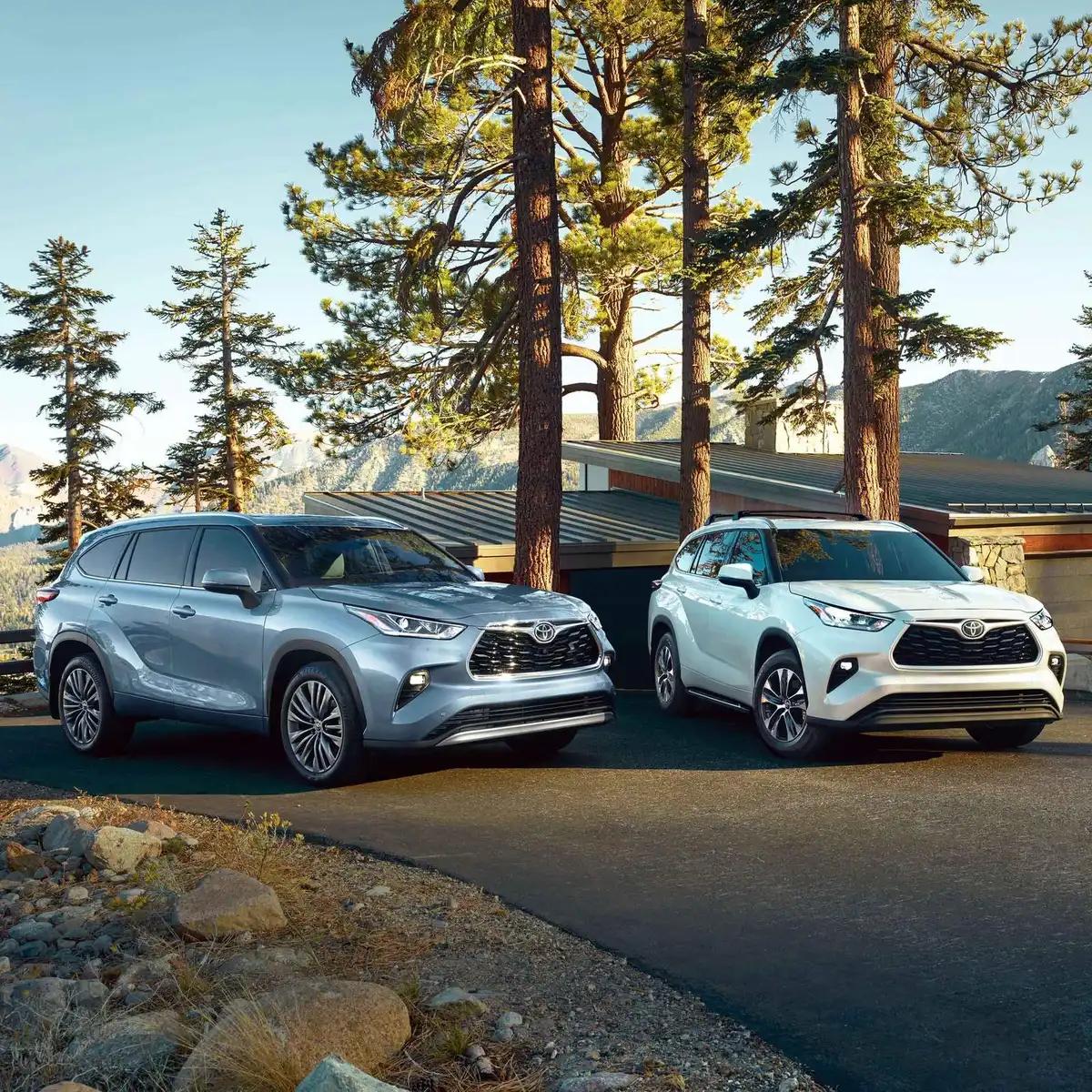 2 Toyota Highlander SUVs parked at a mountain cabin